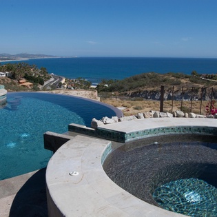 Poolside patio with jacuzzi and infinity pool