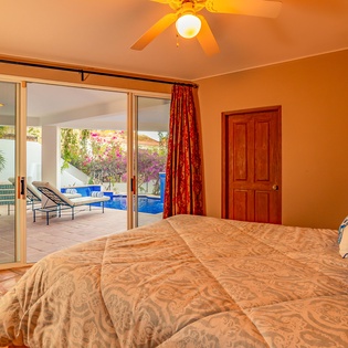 Suite with king bed and door to patio