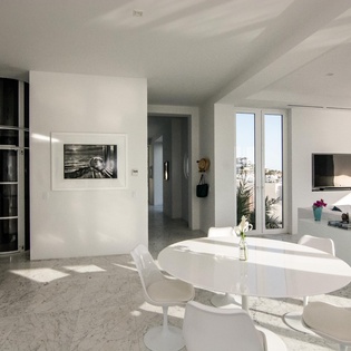 Immerse yourself in this stunning modern space where clean white lines and abundant natural light create your perfect sanctuary for relaxation.