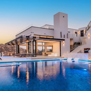 Poolside view of villa during sunset