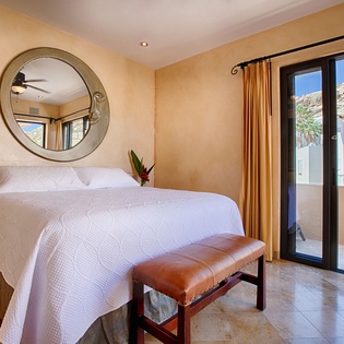 Drift off in this serene bedroom where warm tones embrace you and mountain views greet your mornings. Your private terrace awaits just steps from your plush bed.