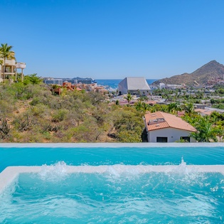 Soak in stunning coastal views while relaxing in your private hot tub overlooking the sparkling sea and mountains.