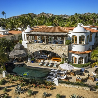 Stunning Mediterranean-style villa with private pool, tropical gardens, and mountain views in an exclusive resort setting.