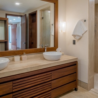 En suite bathroom with double sink and walk in shower