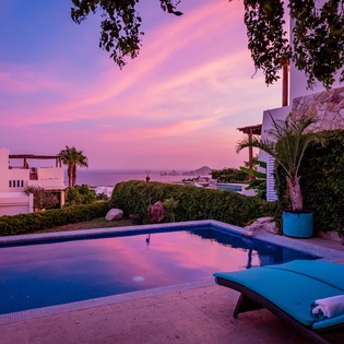 Gorgeous poolside patio with ocean views during sunset