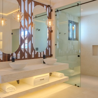 En suite bathroom with double sink and walk in shower