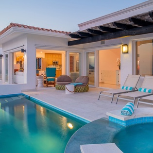 Poolside view of patio during sunset