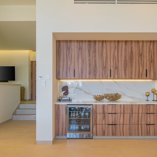 Your sleek kitchenette features beautiful wood cabinetry, marble countertops, and modern appliances for convenient meal prep.