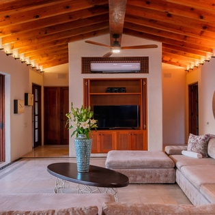 Spacious living area with ocean views and patio access
