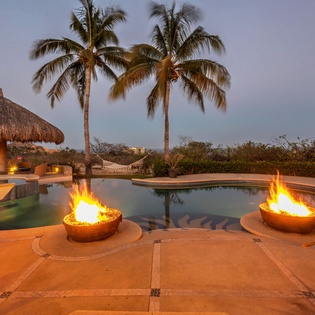 Patio with pool, jacuzzi, and fire pits