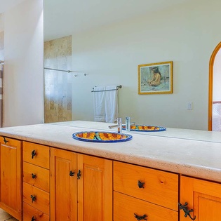 Step into your spacious bathroom, where handcrafted ceramic sinks add a splash of color and dual vanities give you plenty of room to spread out and settle in.
