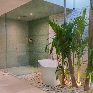 Tropical en suite bathroom with bathtub and walk in shower