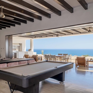 Your vacation home opens to endless ocean views, where indoor and outdoor living blend seamlessly. Gather around the billiard table, relax by the fireplace, or step onto the terrace to feel the sea breeze.