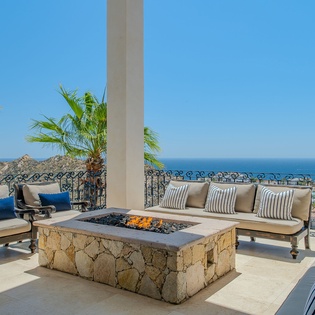 Gather around your private fire pit on this stunning terrace, where ocean views and palm breezes create the perfect evening retreat.