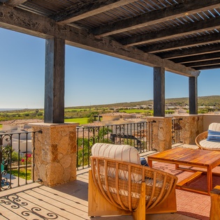 Unwind on your private terrace with sweeping views across rolling hills and manicured grounds, where rustic charm meets outdoor comfort.