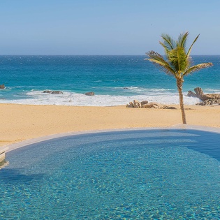 Your private infinity pool meets pristine golden sand and turquoise ocean. Dip in while swaying palms frame paradise—pure coastal serenity awaits.