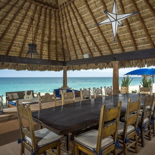 Dine oceanside under this stunning palapa, where turquoise waters and white sand create your perfect tropical backdrop for memorable meals.
