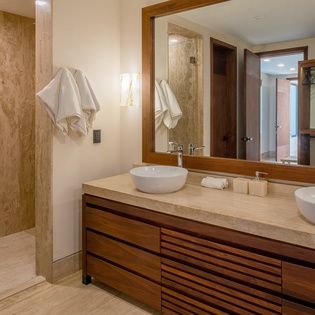 En suite bathroom with walk in shower and closet
