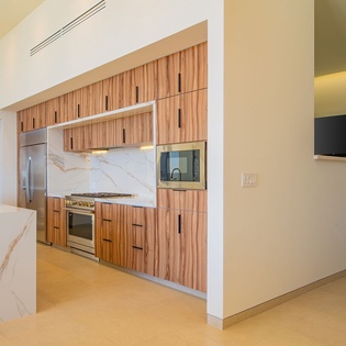 Your modern kitchen features sleek wood cabinetry, marble backsplash, and premium appliances for effortless cooking and entertaining.