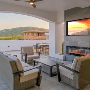 Outdoor living area with fire places and TV