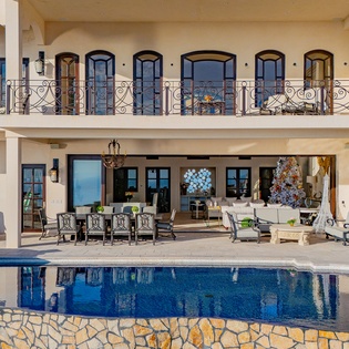 Poolside view of patio and villa exterior