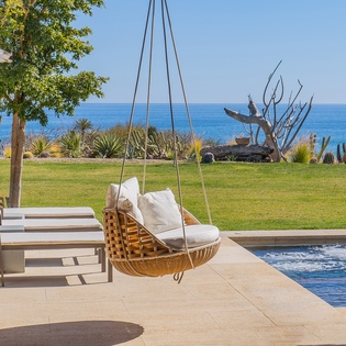 Poolside patio with hammock and ocean view