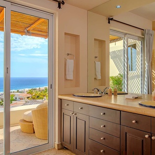 Wake up to breathtaking ocean views from your elegant bathroom, where spa-inspired double vanities and a private balcony create the perfect morning retreat.