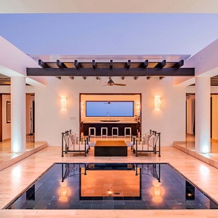 Your private oasis awaits with an elegant indoor pool, stylish lounge seating, and stunning open-air design that brings the evening sky right to you.