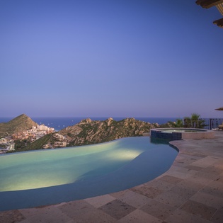 Patio with city and ocean view during sunset