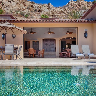 Your private oasis awaits—sparkling pool, shaded lounging areas, and dramatic mountain views create the perfect desert escape for relaxation and outdoor living.