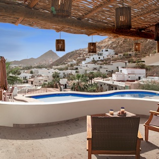 Soak up stunning mountain views while you relax by your private pool, perfectly shaded by rustic pergola beams.