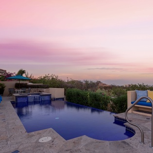 Poolside patio during sunset with ocean views