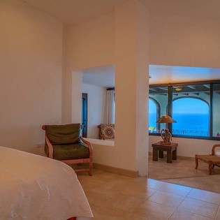 Step into your private retreat where calming ocean blues frame stunning views. Unwind in your cozy seating area and let the sea horizon become your daily escape.