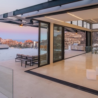living room fully opens to expansive ocean view terrace