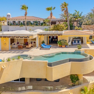 A stunning elevated pool creates the perfect centerpiece for your tropical getaway, surrounded by luxurious outdoor living spaces.