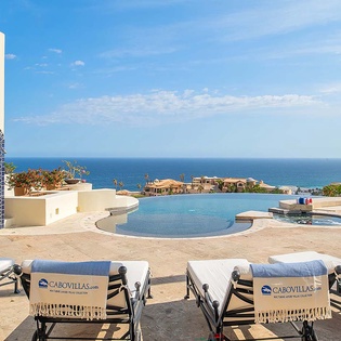 Stunning infinity pool overlooking the endless azure sea—perfect for your morning coffee or sunset lounging on plush sunbeds.