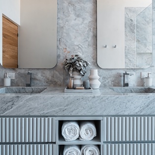 Unwind in your spa-like marble bathroom with dual vanities, elegant mirrors, and plush towels awaiting your arrival.