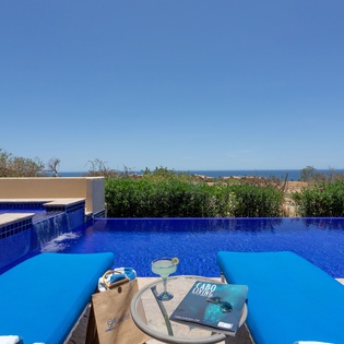 Lounge by the pool on a sunny day with an incredible view