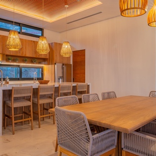 Step into your modern kitchen where warm wood and stunning pendant lights create the perfect space for cooking and gathering.