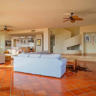 Bright tile floors and high ceilings create a breezy, airy feel in this spacious open-concept living area, where you'll find plenty of room to relax and unwind.