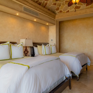 Sink into luxury with crisp white linens and warm earth tones creating your perfect retreat.