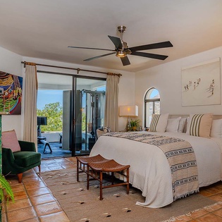Settle into your serene retreat where vibrant art and natural light create the perfect ambiance for rest. Step through the glass doors to your private outdoor oasis.