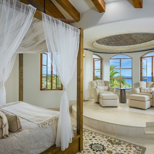 Drift into dreams in your elegant four-poster bed while ocean breezes flow through the windows of your luxurious retreat.
