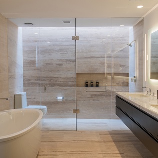 En suite bathroom with walk in shower and bathtub