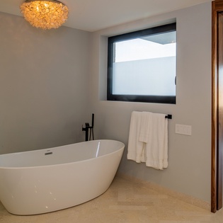 En-suite bathroom with bathtub