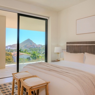 Wake up to breathtaking mountain vistas from your serene bedroom, where floor-to-ceiling windows frame nature's masterpiece perfectly.