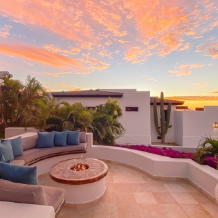 Patio with fire pit during sunset