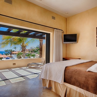 Wake up to breathtaking ocean and palm tree views framed by your private terrace. Your serene bedroom opens seamlessly to the sea, inviting you to step outside and savor coastal living at its finest.