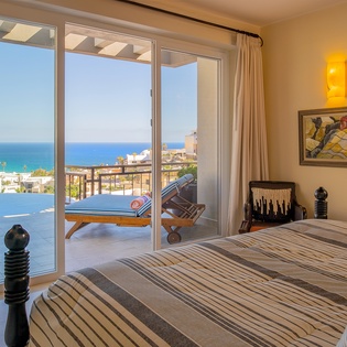 Bedroom suite with patio access and ocean views