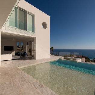 Modern villa featuring stunning sea views and private pool on expansive terrace with contemporary architecture.